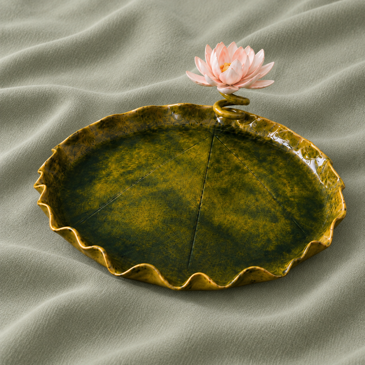 Green leaf-shaped ceramic platter with a pink waterlily